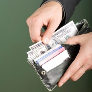 person pulling cash out of their wallet. 