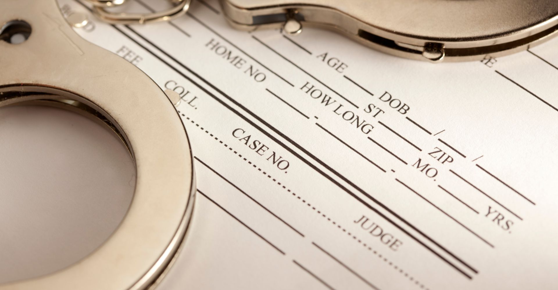 Handcuffs on a partially filled bail bond form.